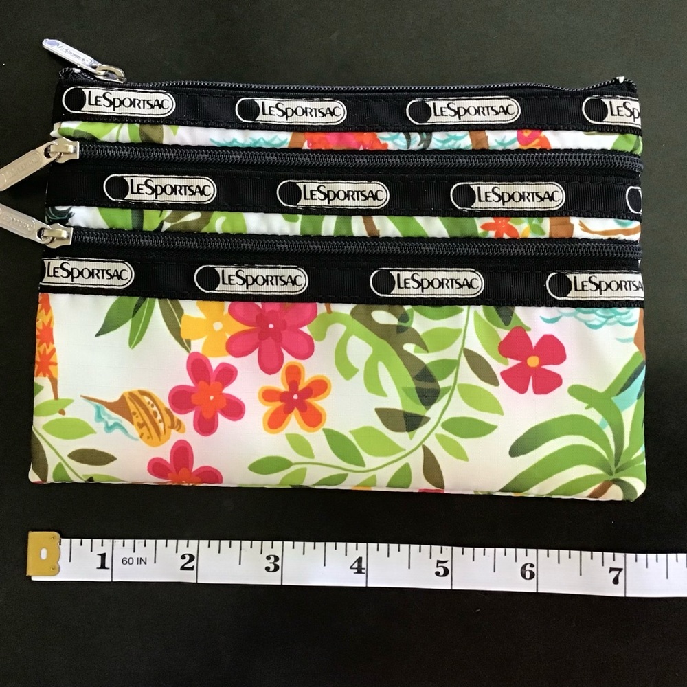 LeSportsac Multicolor Floral  Hula Girl Pouch
3 zipper pockets
5” X 7”
NWOT